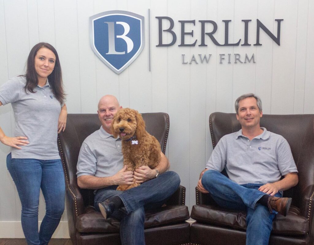 Workers compensation lawyers Amanda, Stephen and Thomas and the office dog, Duncan, at Berlin Law Firm