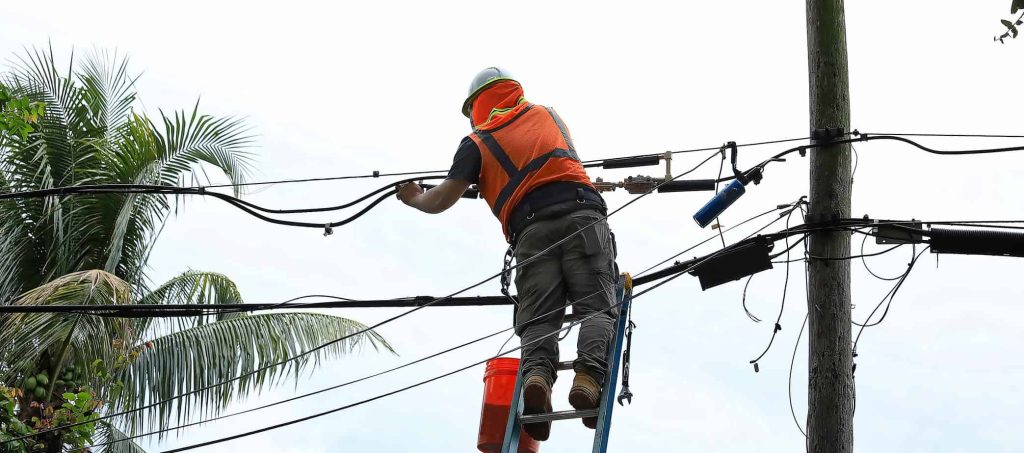 Florida worker on a Ladder working on Power lines