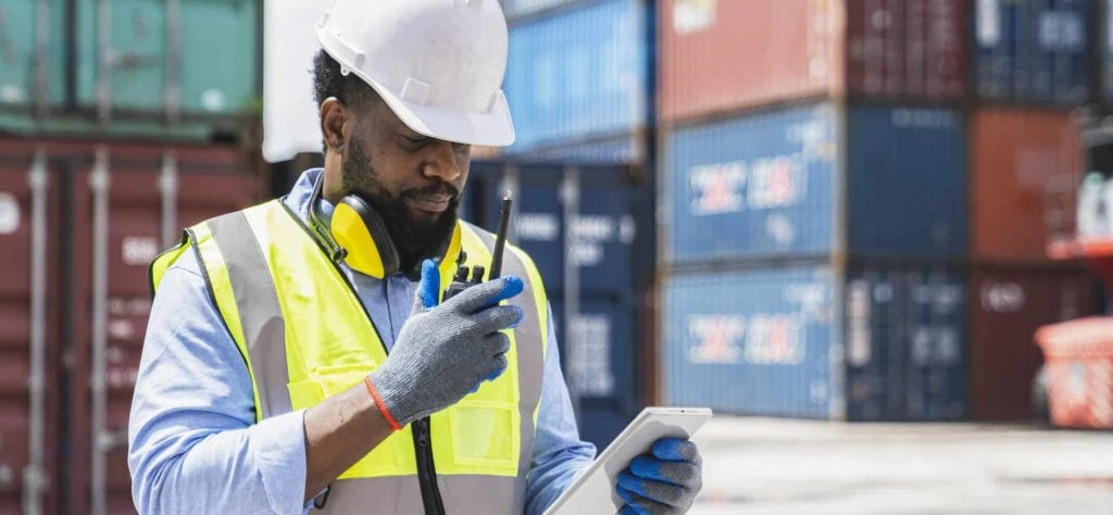 Shipyard worker with walkie talkie