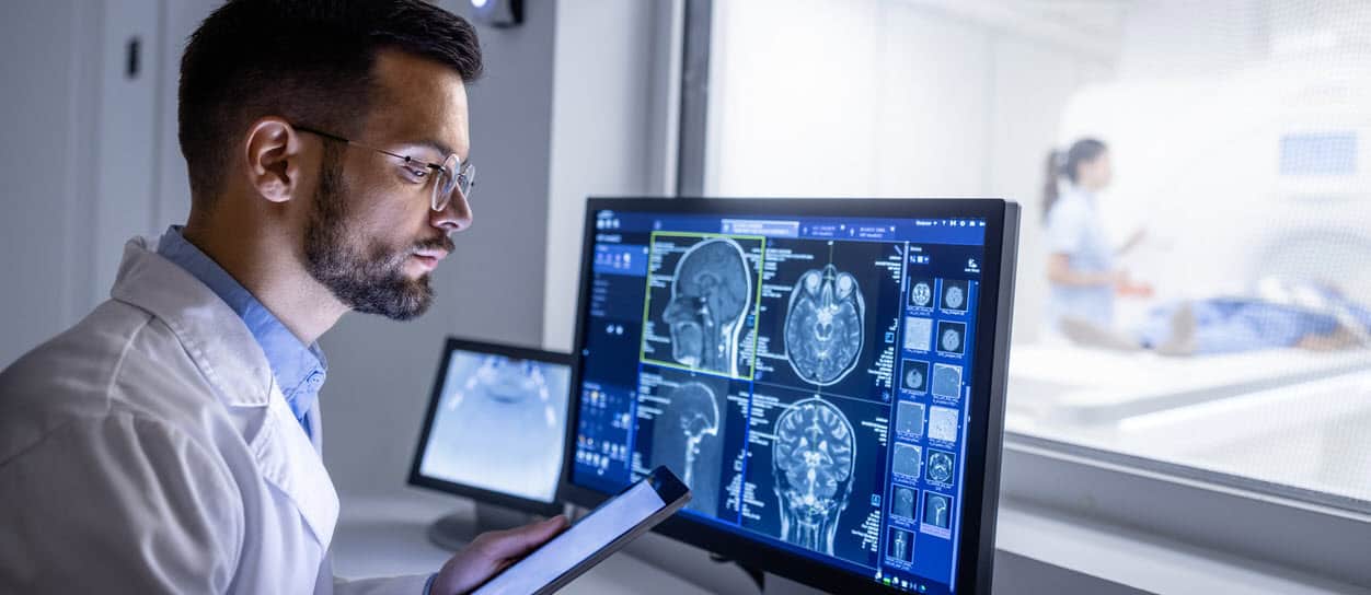 Doctor examining X-ray images in MRI control room